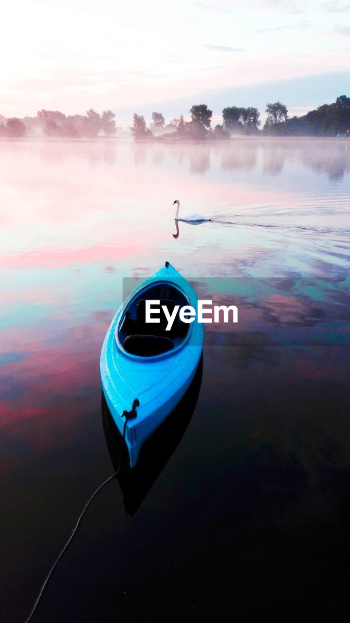 High angle view of kayak moored in lake with reflection