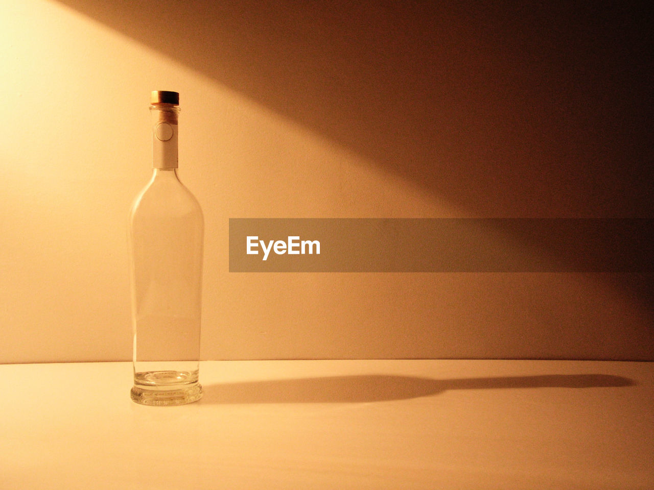 Close-up of empty wine bottles on table during sunny day