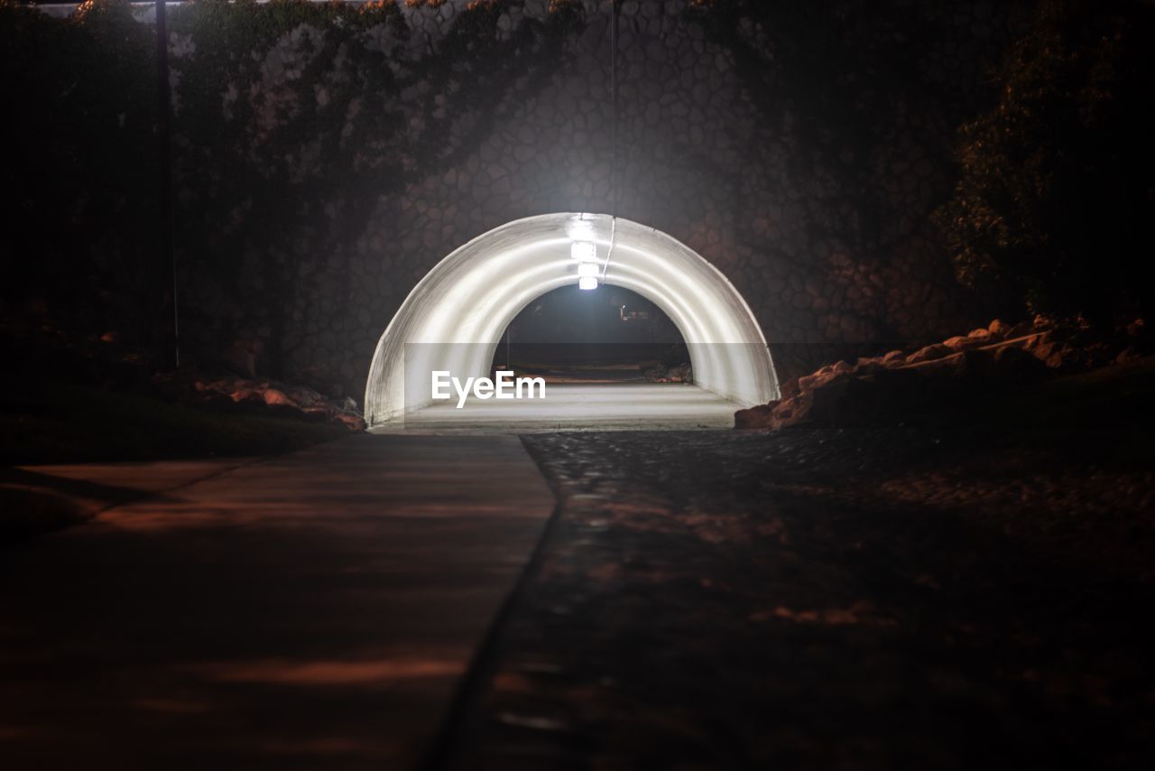 View of illuminated tunnel at night