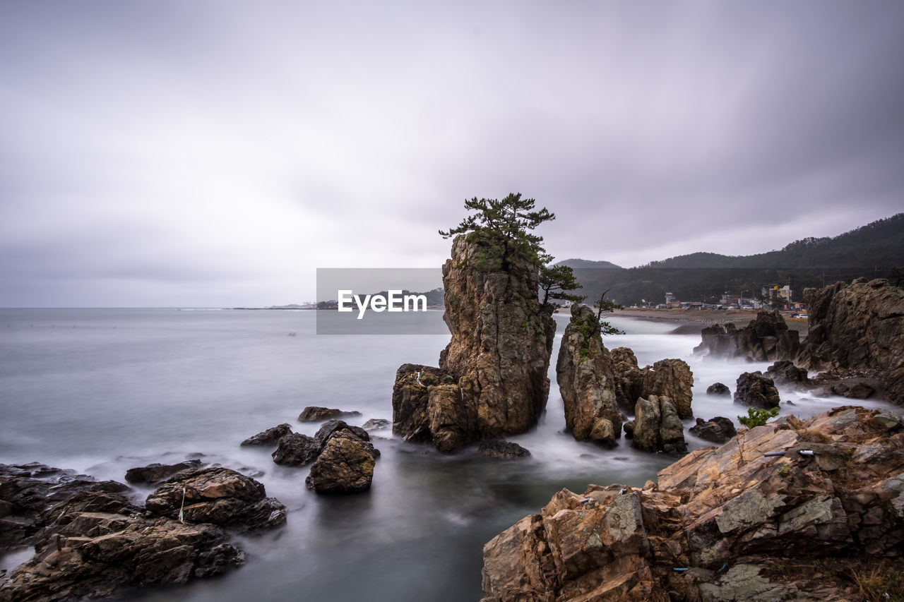 Panoramic view of rocks on the beach against sky