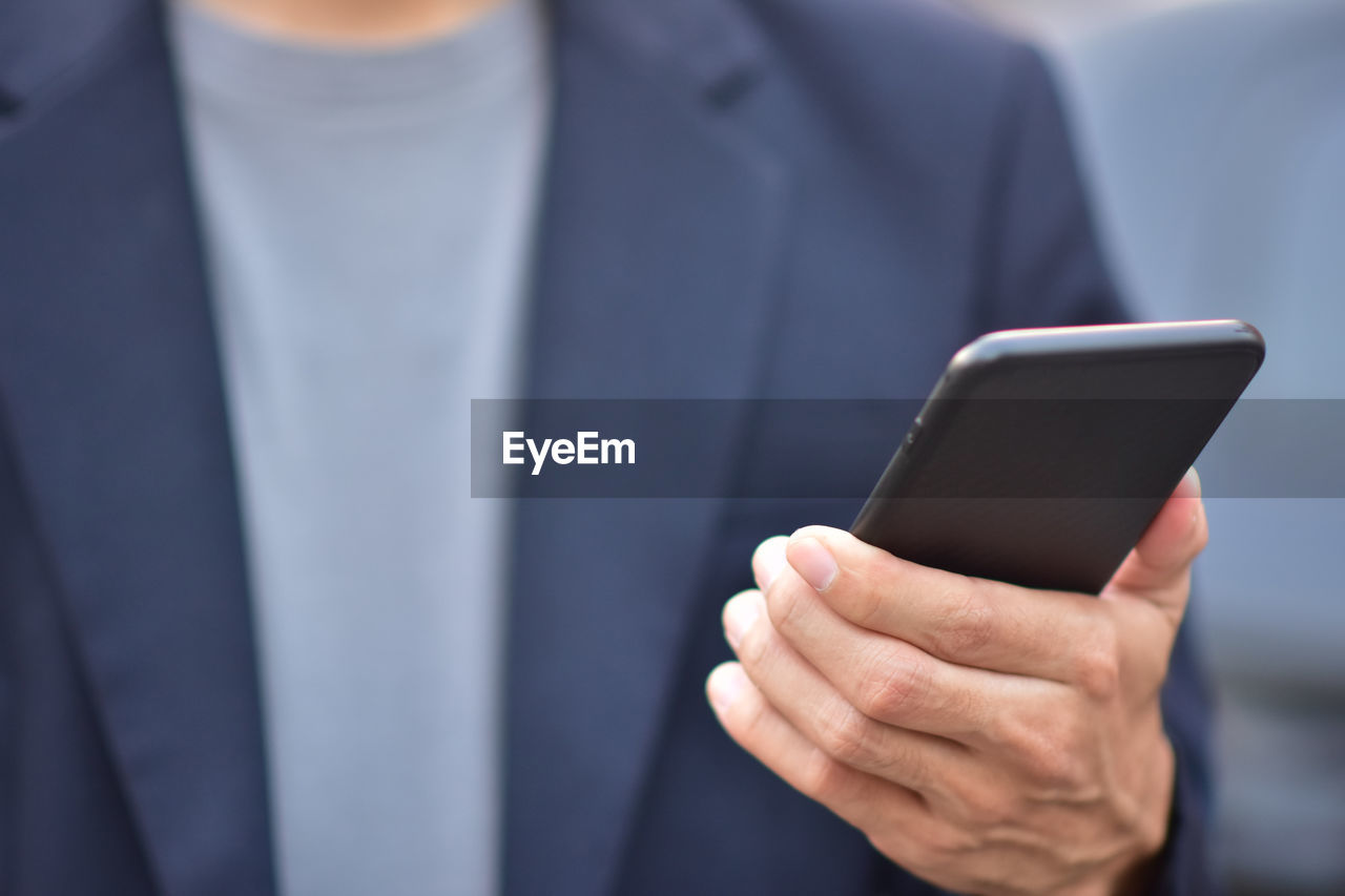 Close-up of man using mobile phone