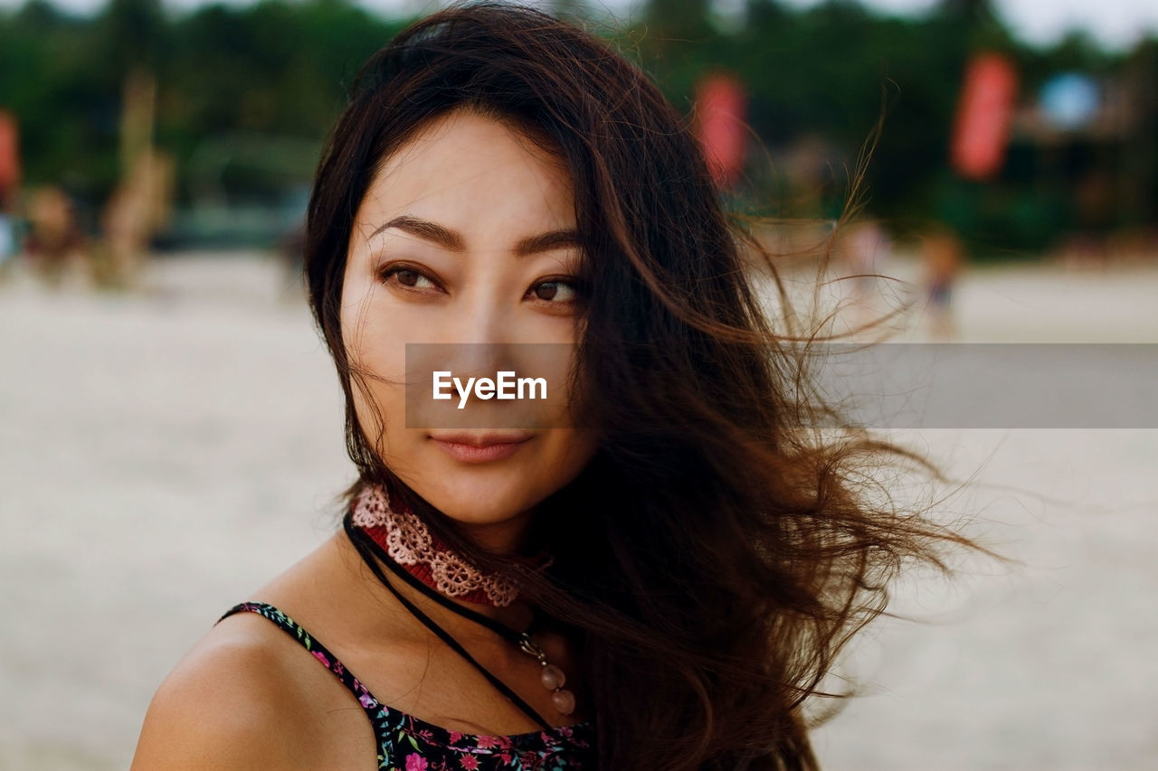 Portrait of young asian woman with long hair in wind