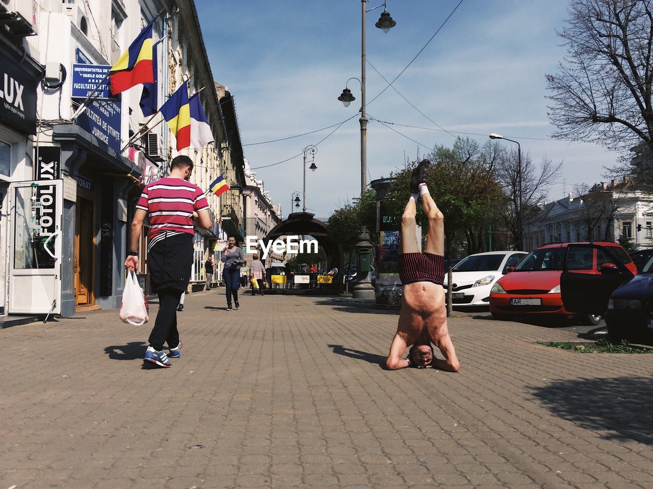 REAR VIEW OF WOMAN ON CITY STREET