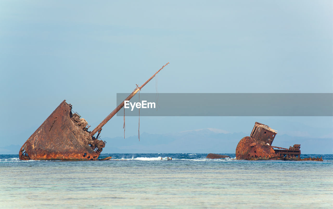 Scenic view of rusty ship against clear sky