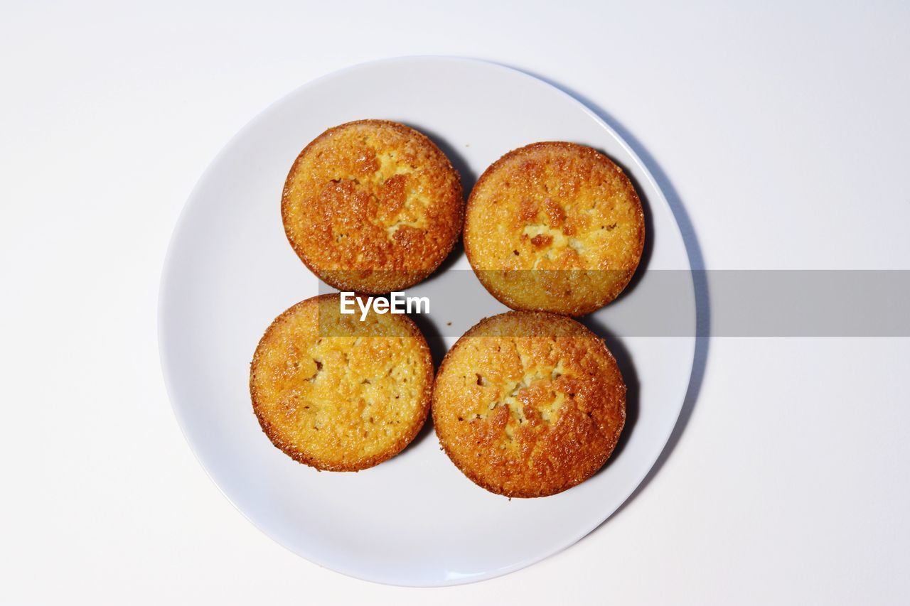 Directly above shot of bread in plate against white background