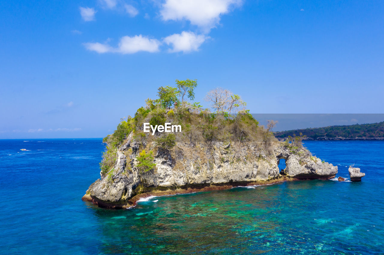 SCENIC VIEW OF SEA AGAINST ROCK FORMATION