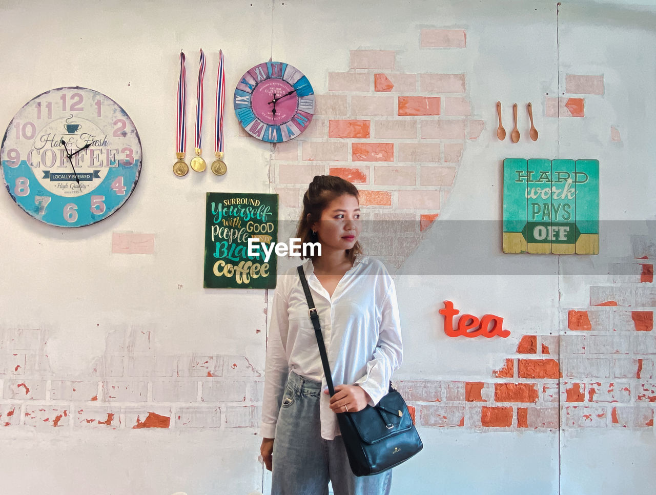 Portrait of woman standing against wall