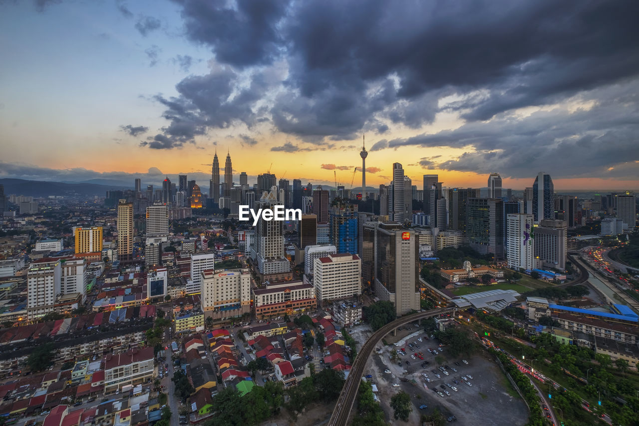 High angle view of illuminated buildings against sky during sunset