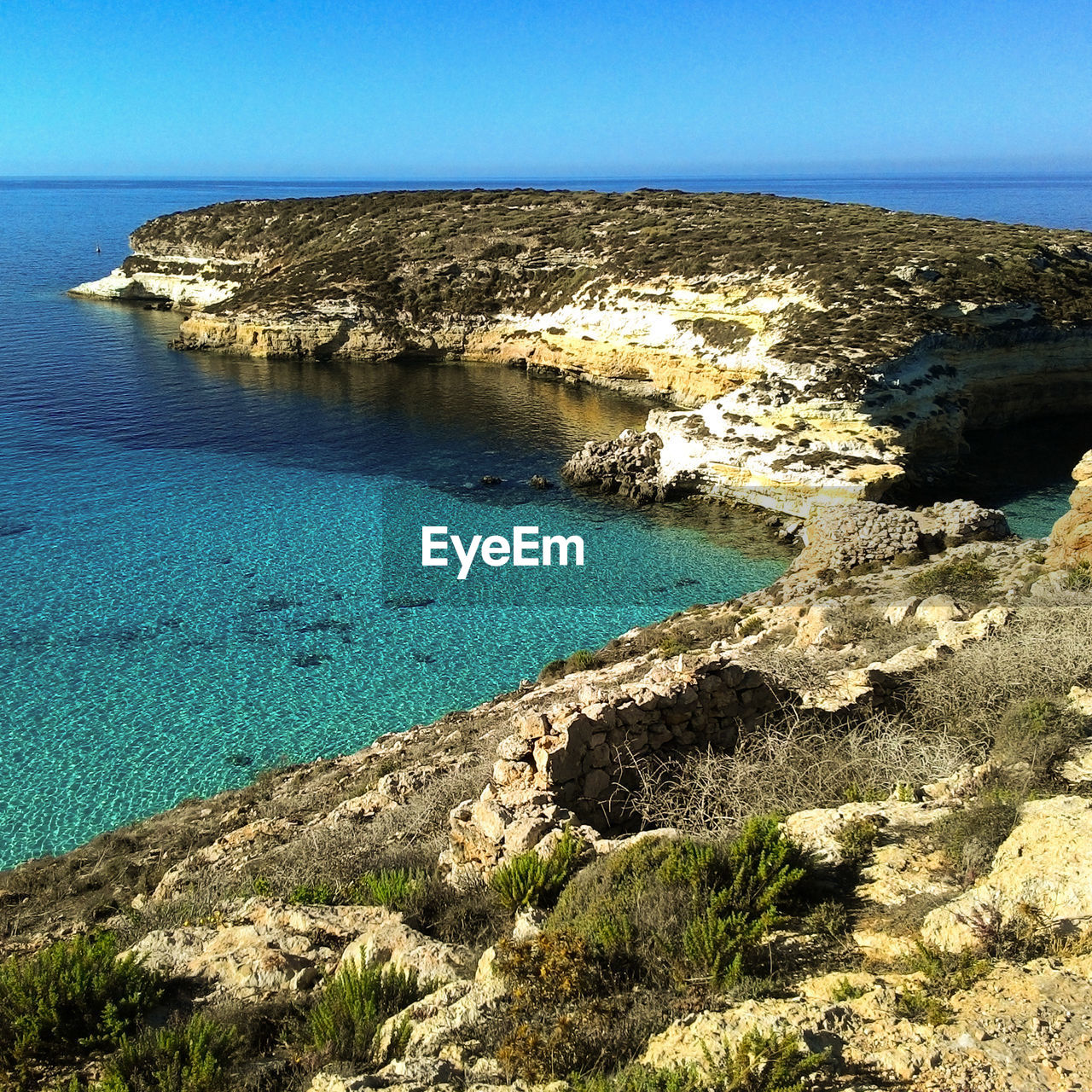 Scenic view of sea against clear blue sky