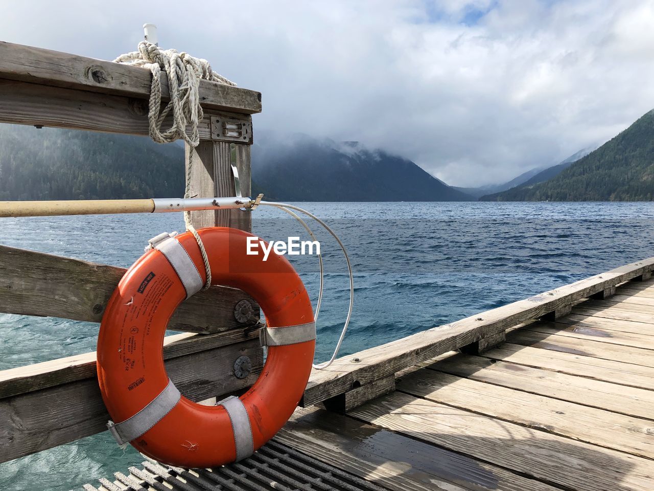 View of pier over lake against sky