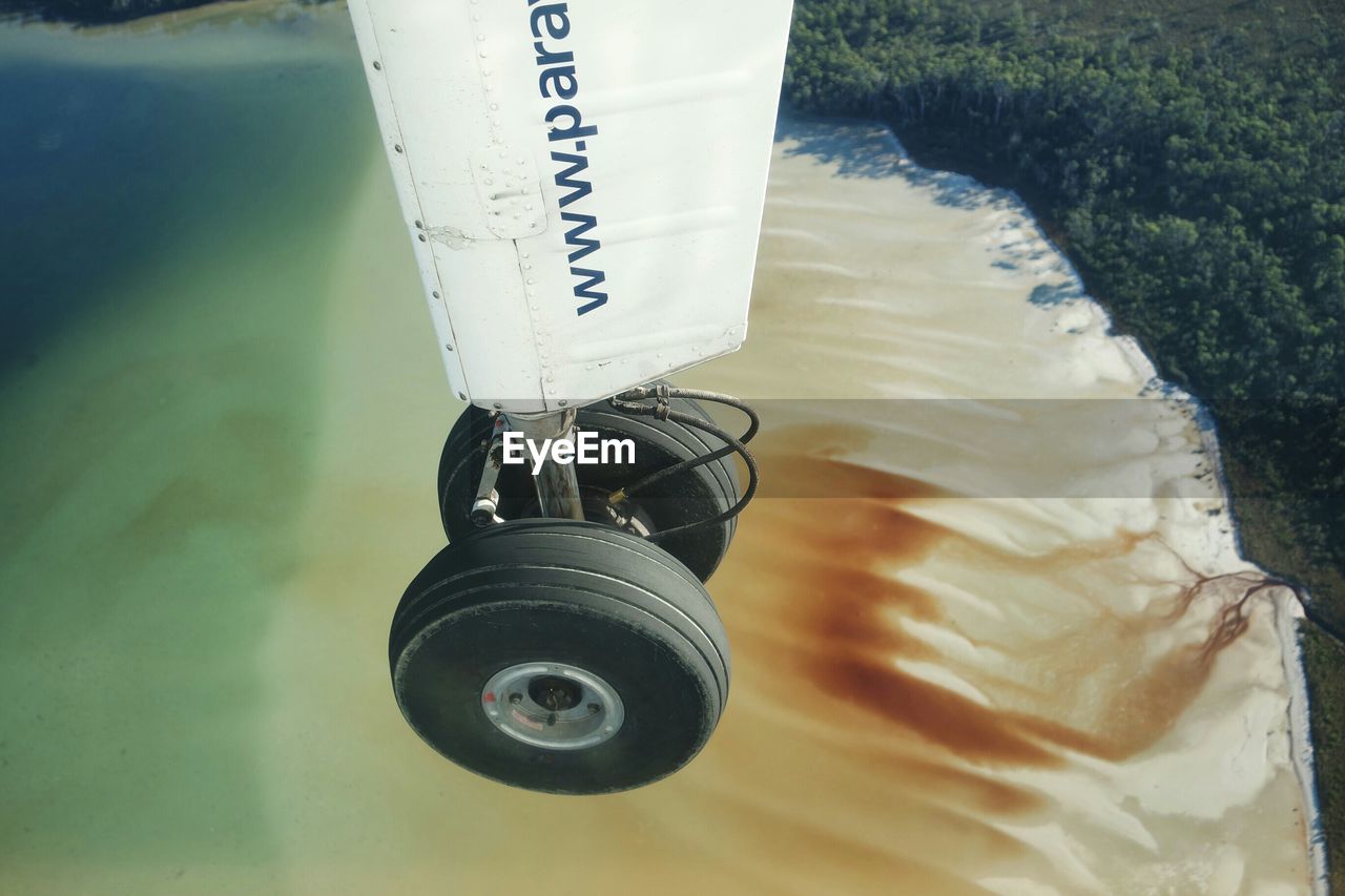 Cropped image of airplane flying over beach