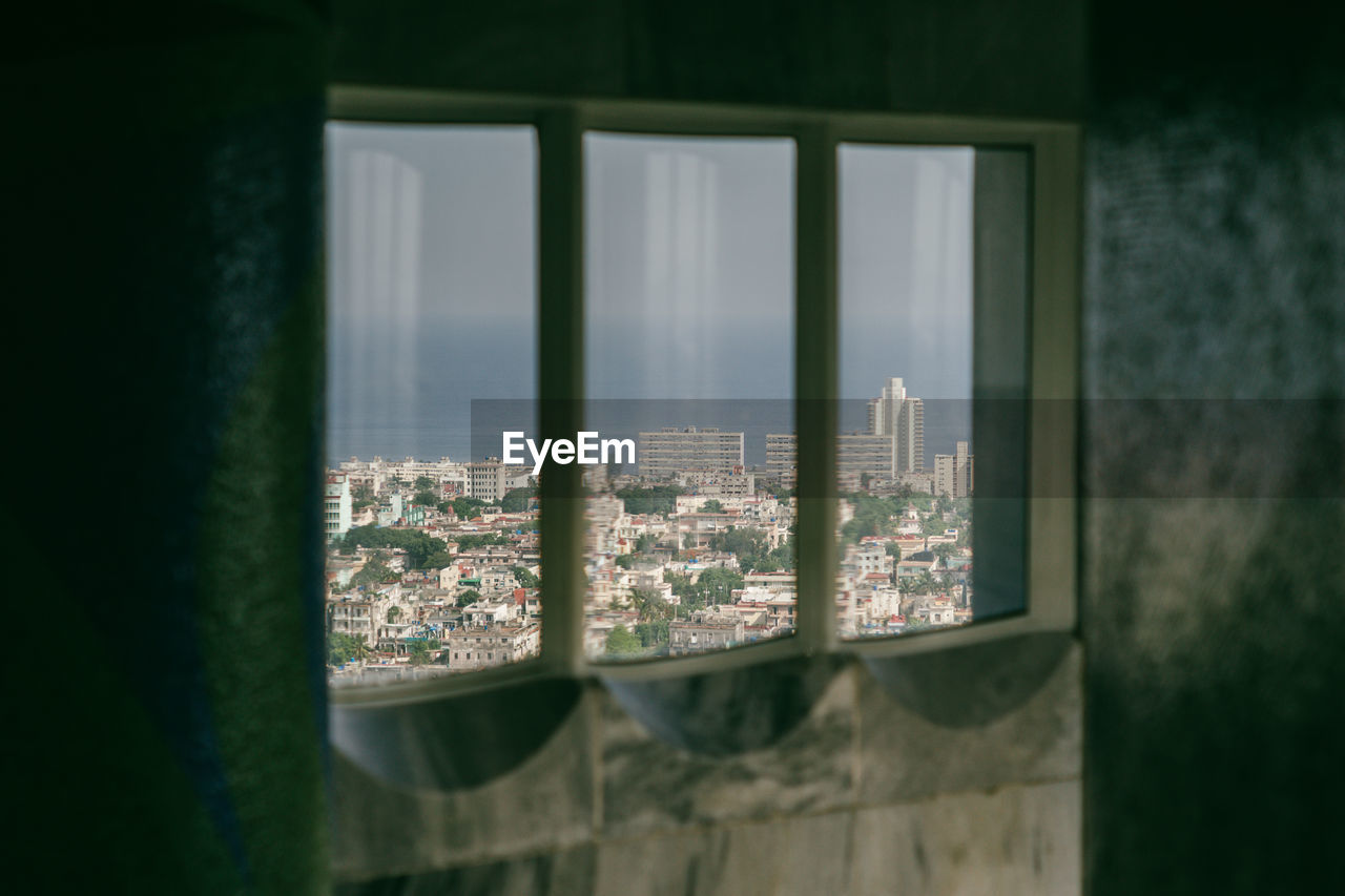 High angle view of cityscape seen through glass window