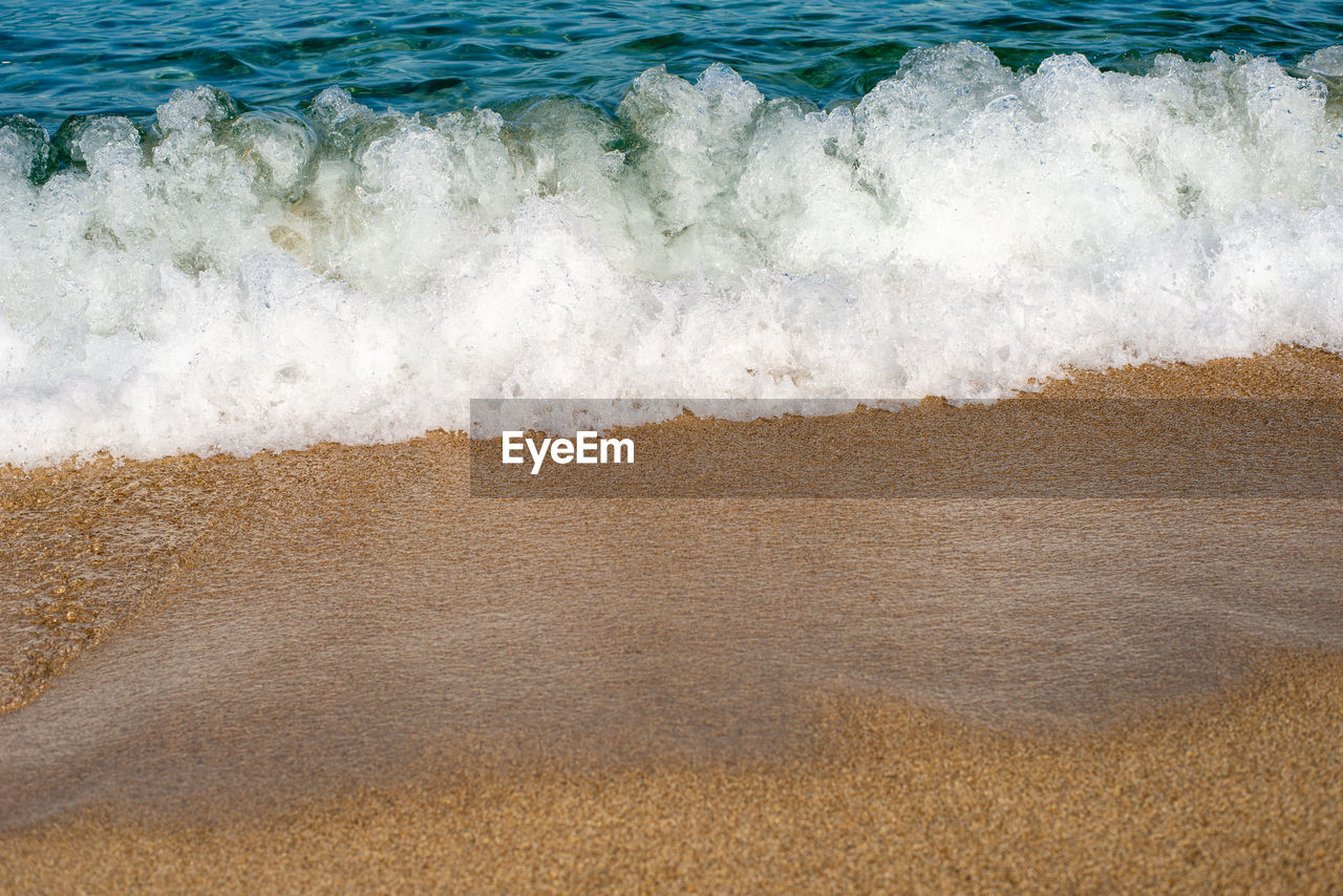 HIGH ANGLE VIEW OF WAVE ON SHORE