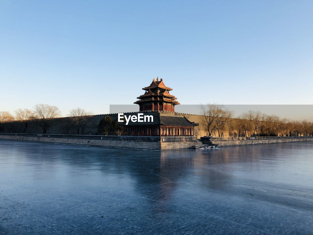 Forbidden city with frozen water against clear blue sky