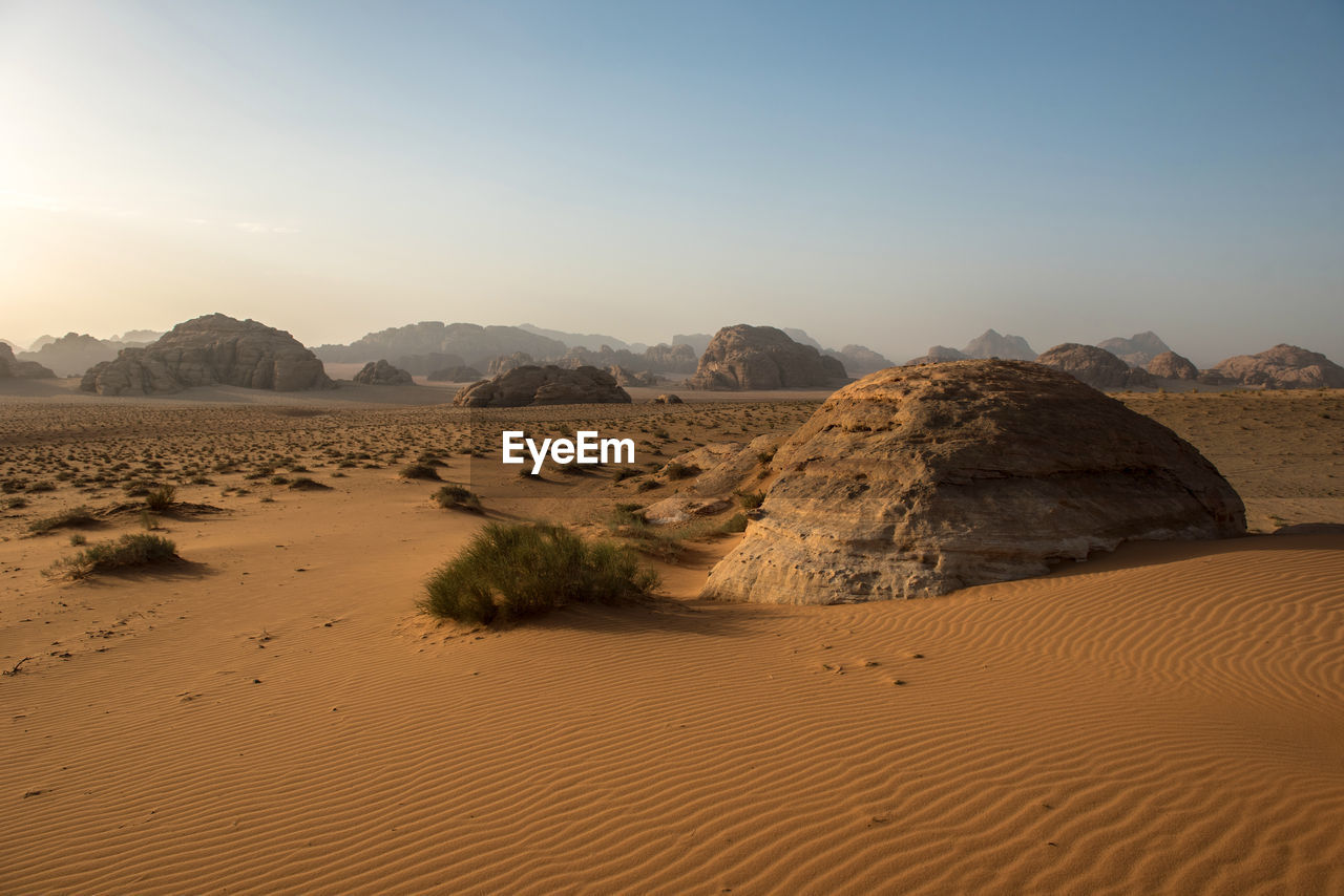 Sand dunes and sandstone cliffs in wadi rum desert , jordan