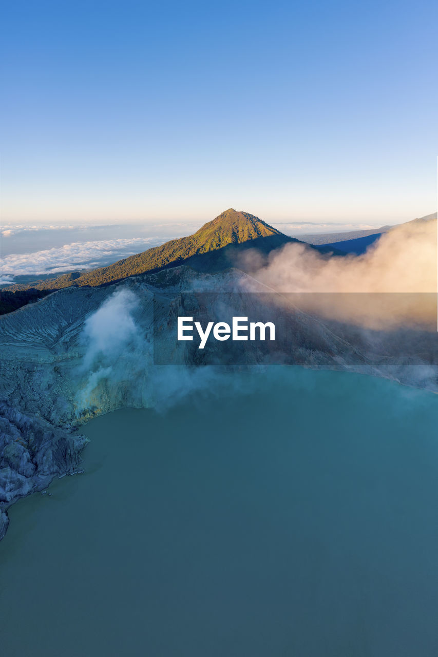 VIEW OF VOLCANIC MOUNTAIN AGAINST SKY