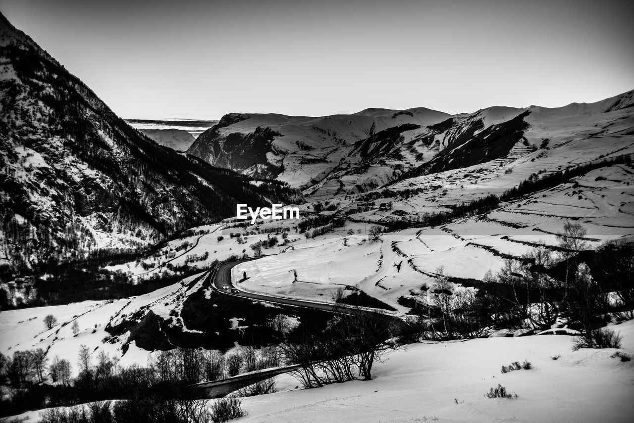 Scenic view of snow covered mountains against sky