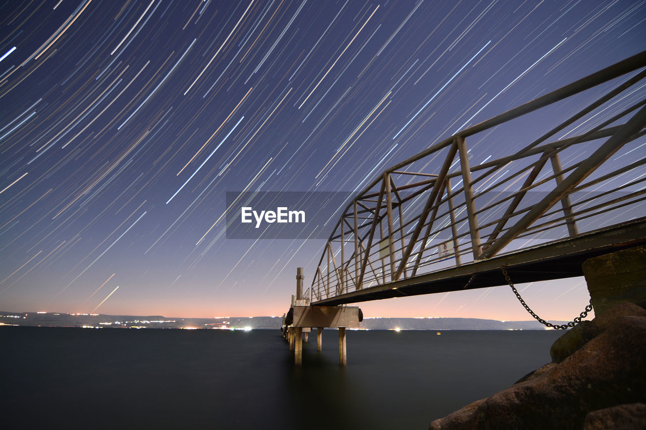 Startrails over a pier at the sea of galilee