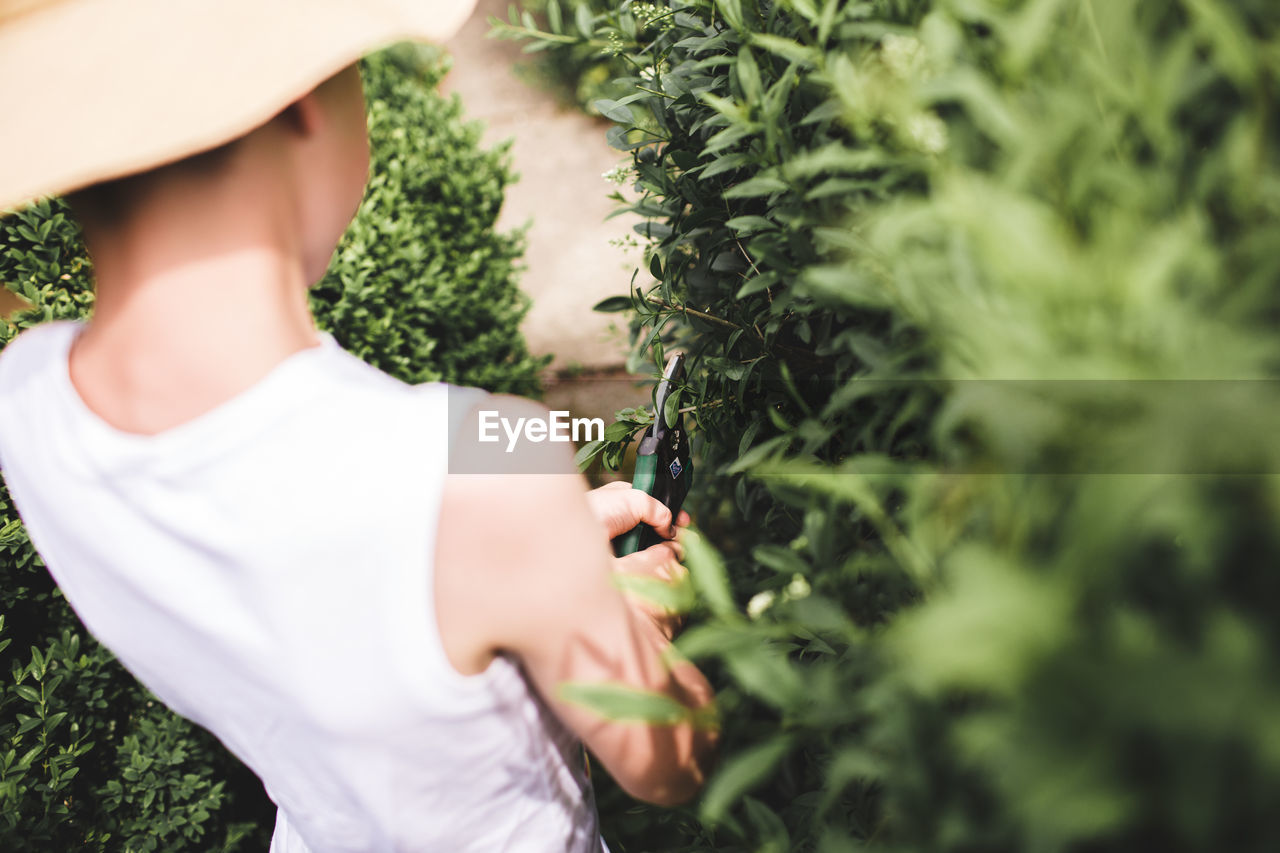 Midsection of working gardener 