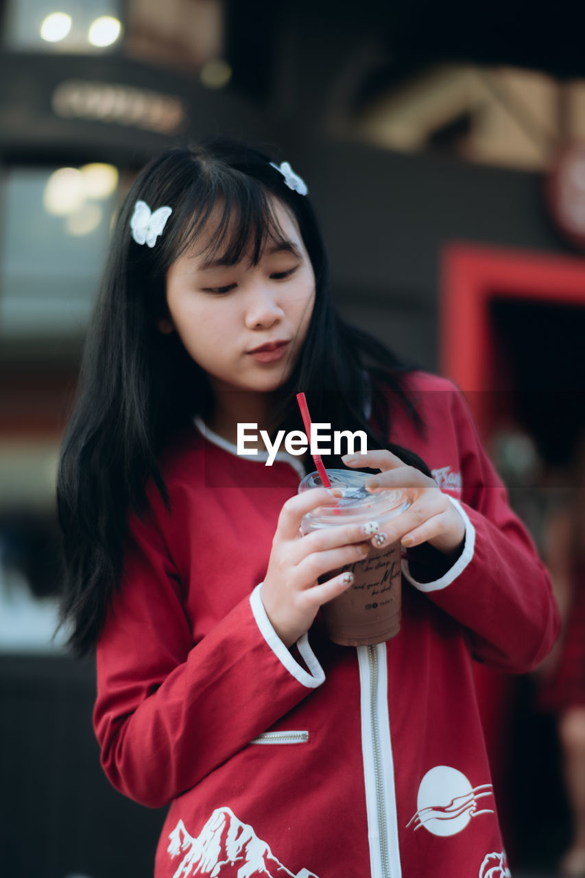 Girl drinking cold coffee outdoors