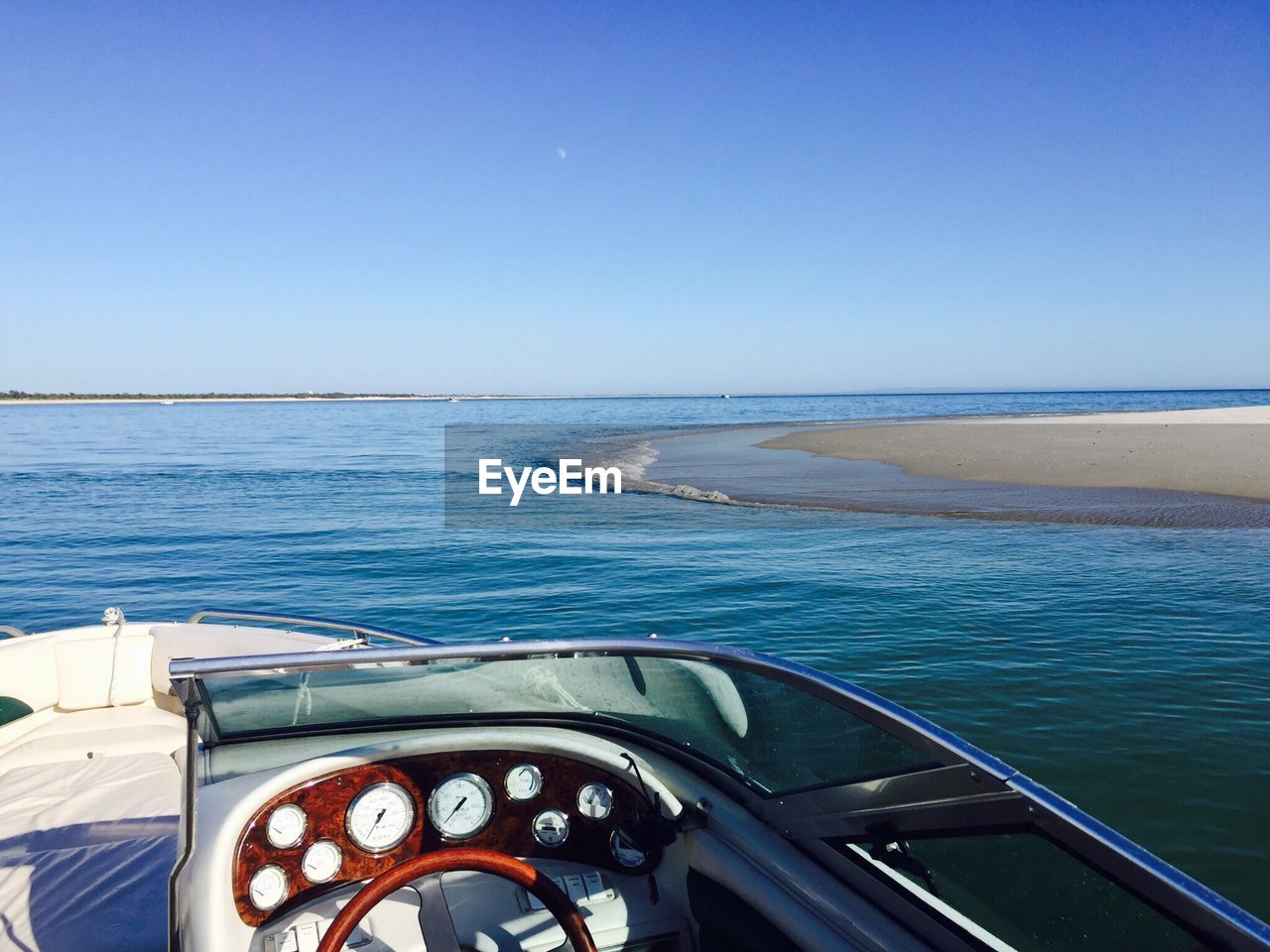 Motorboat in sea by praia de troia against sky