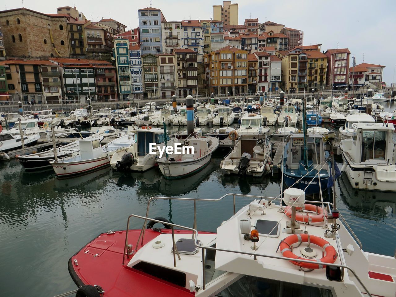 BOATS MOORED IN HARBOR