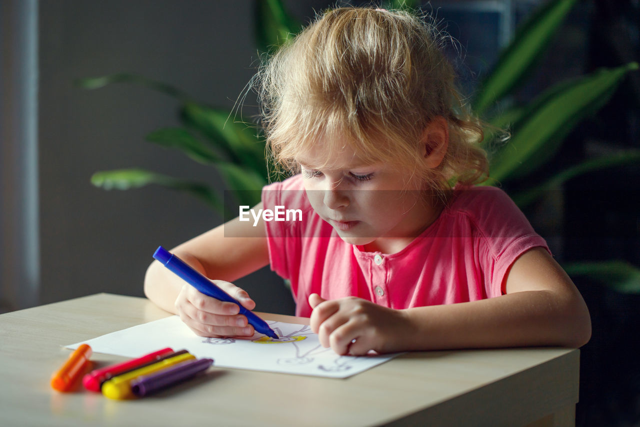 close-up of boy drawing on book