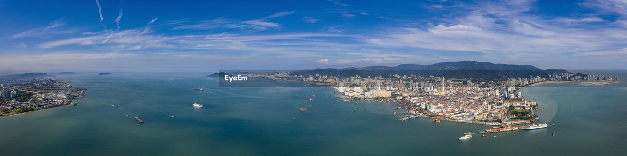 High angle view of sea and cityscape against sky