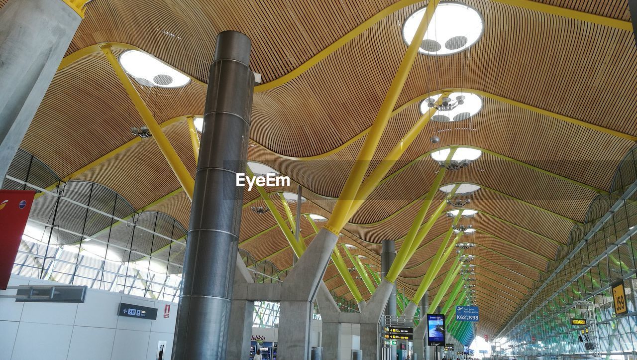 LOW ANGLE VIEW OF ILLUMINATED CEILING LIGHTS