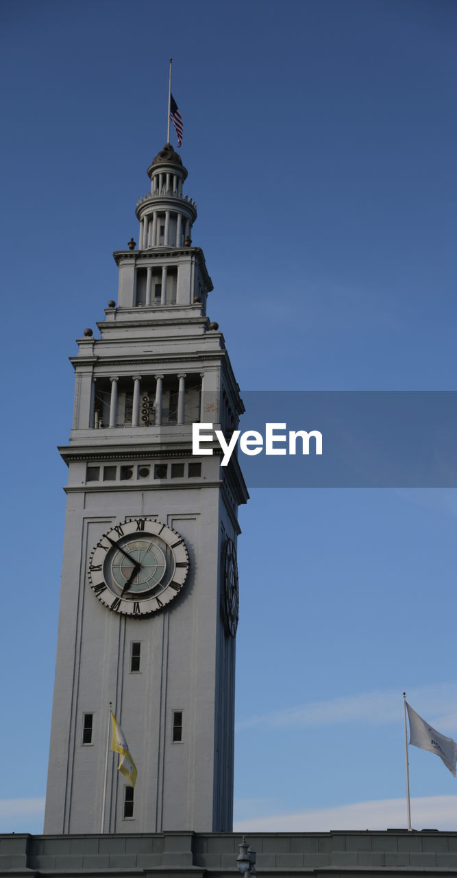 Low angle view of clock tower against sky