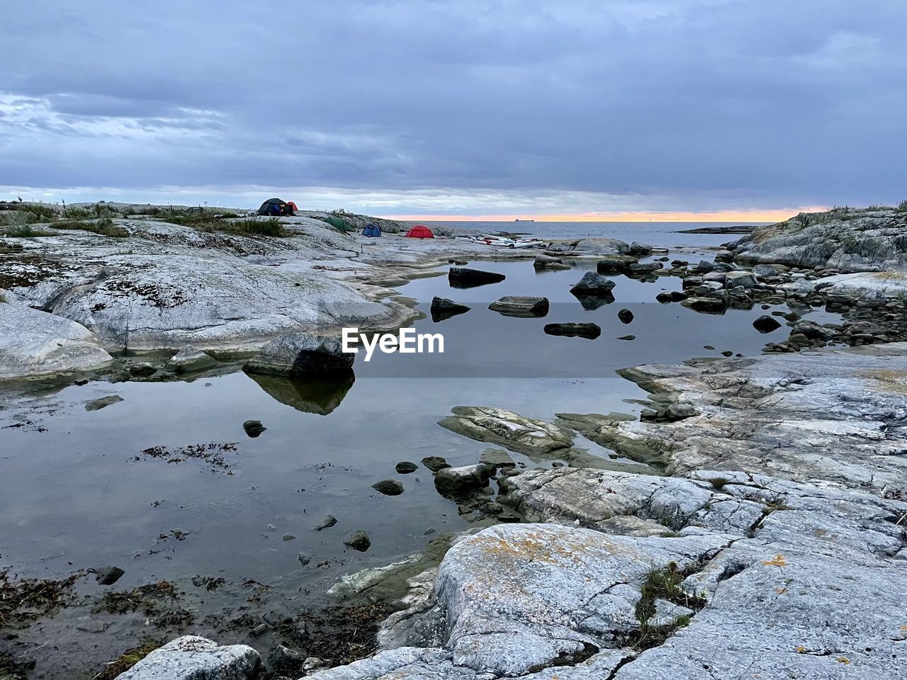 water, shore, coast, sky, sea, environment, nature, cloud, rock, landscape, scenics - nature, land, beauty in nature, snow, ocean, beach, travel, wave, winter, travel destinations, body of water, reflection, mountain, cold temperature, wilderness, outdoors, no people, tourism, tranquility, ice, non-urban scene, day, coastline, tranquil scene, social issues, overcast, lagoon