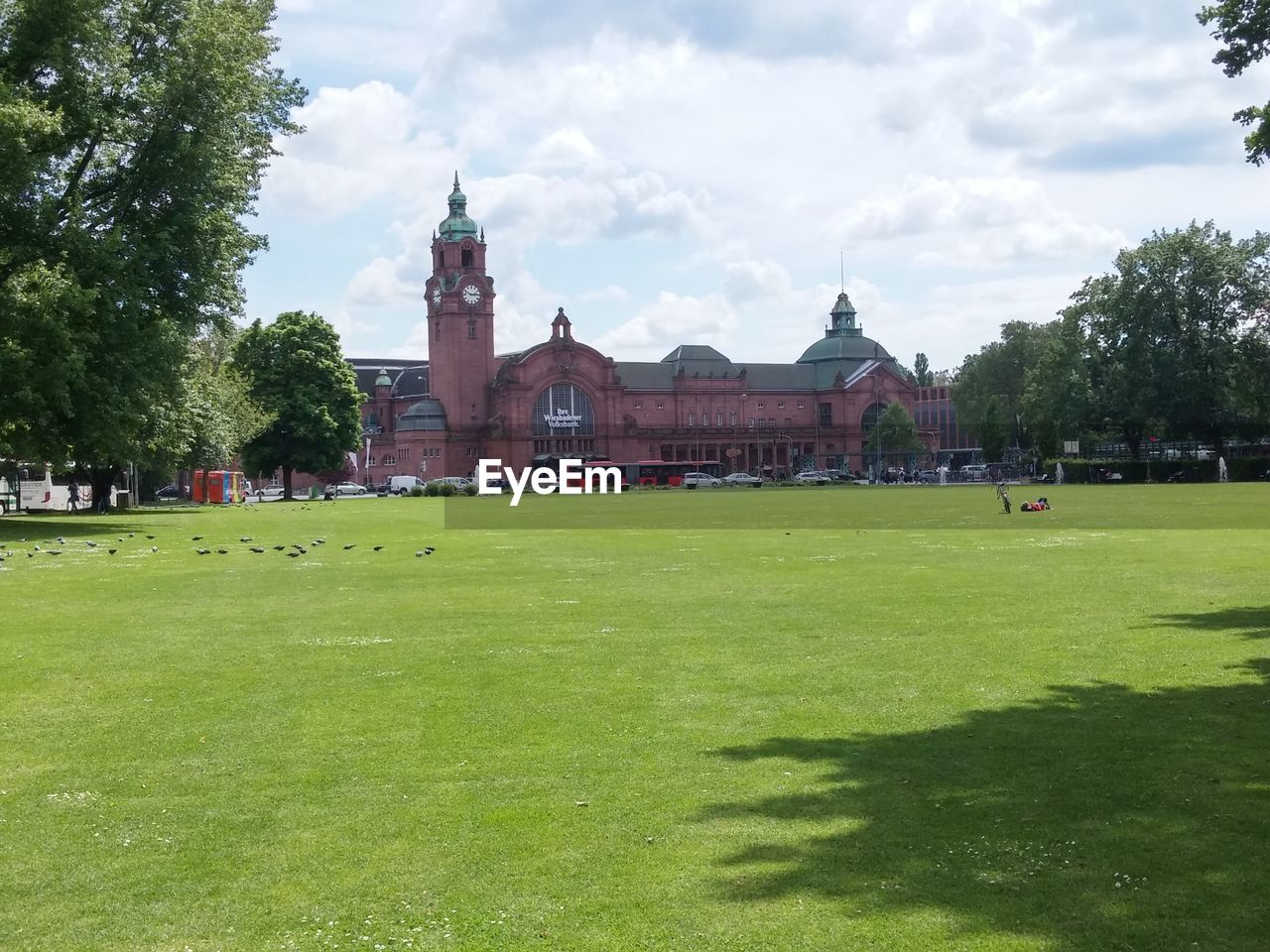 VIEW OF LAWN WITH BUILDINGS IN BACKGROUND