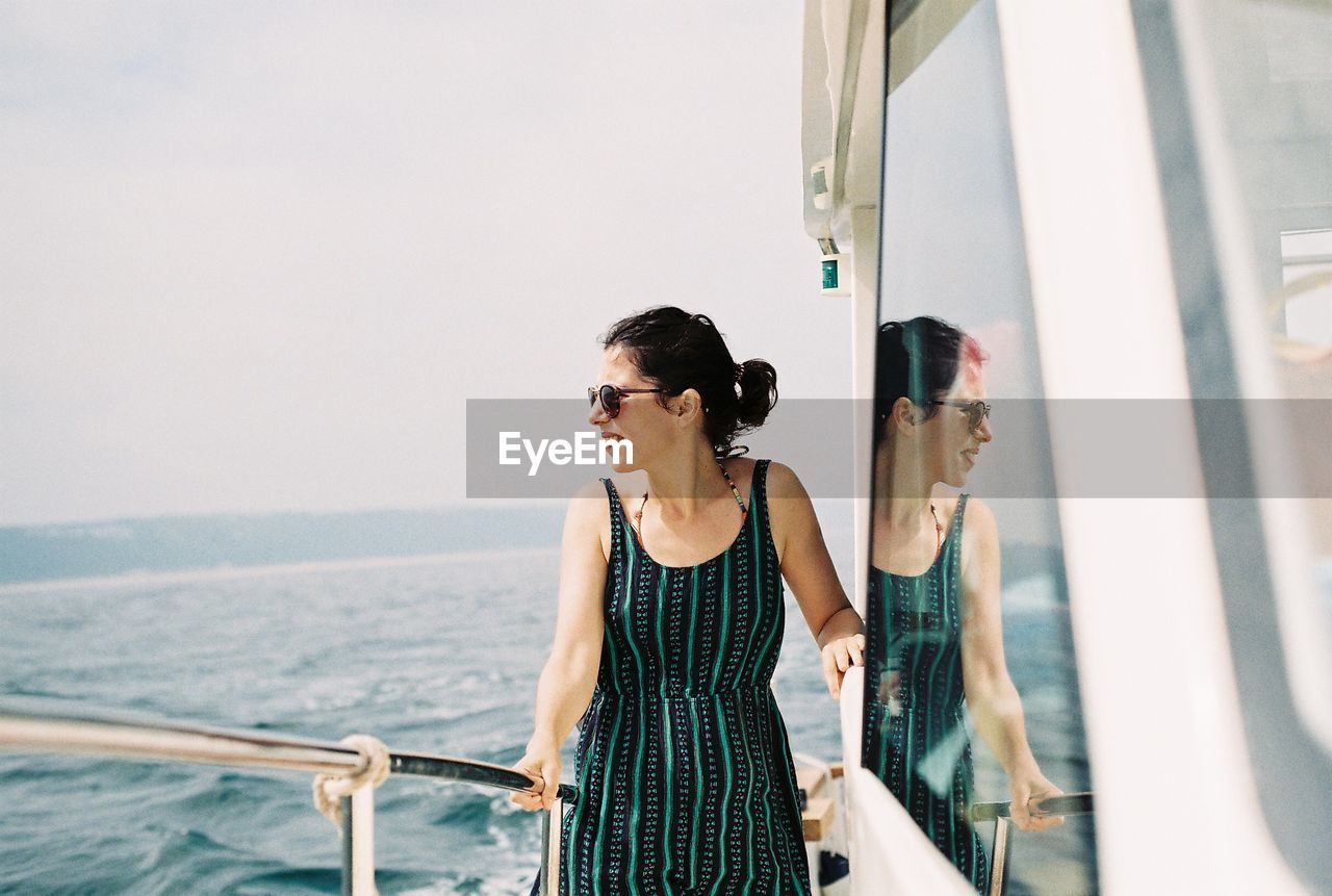 Smiling woman standing in boat