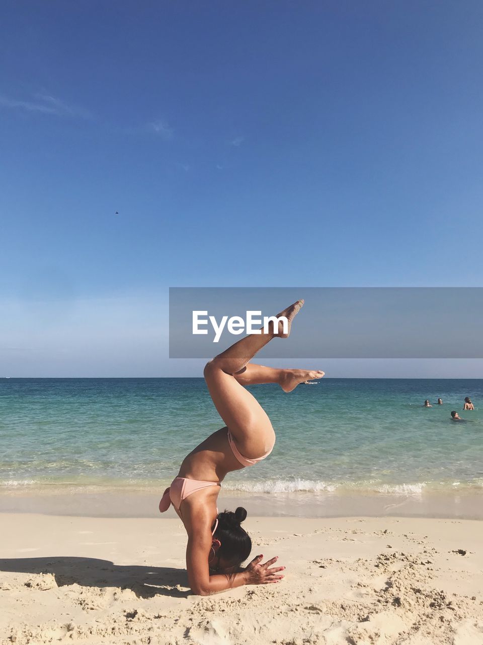 MAN ON BEACH AGAINST SKY