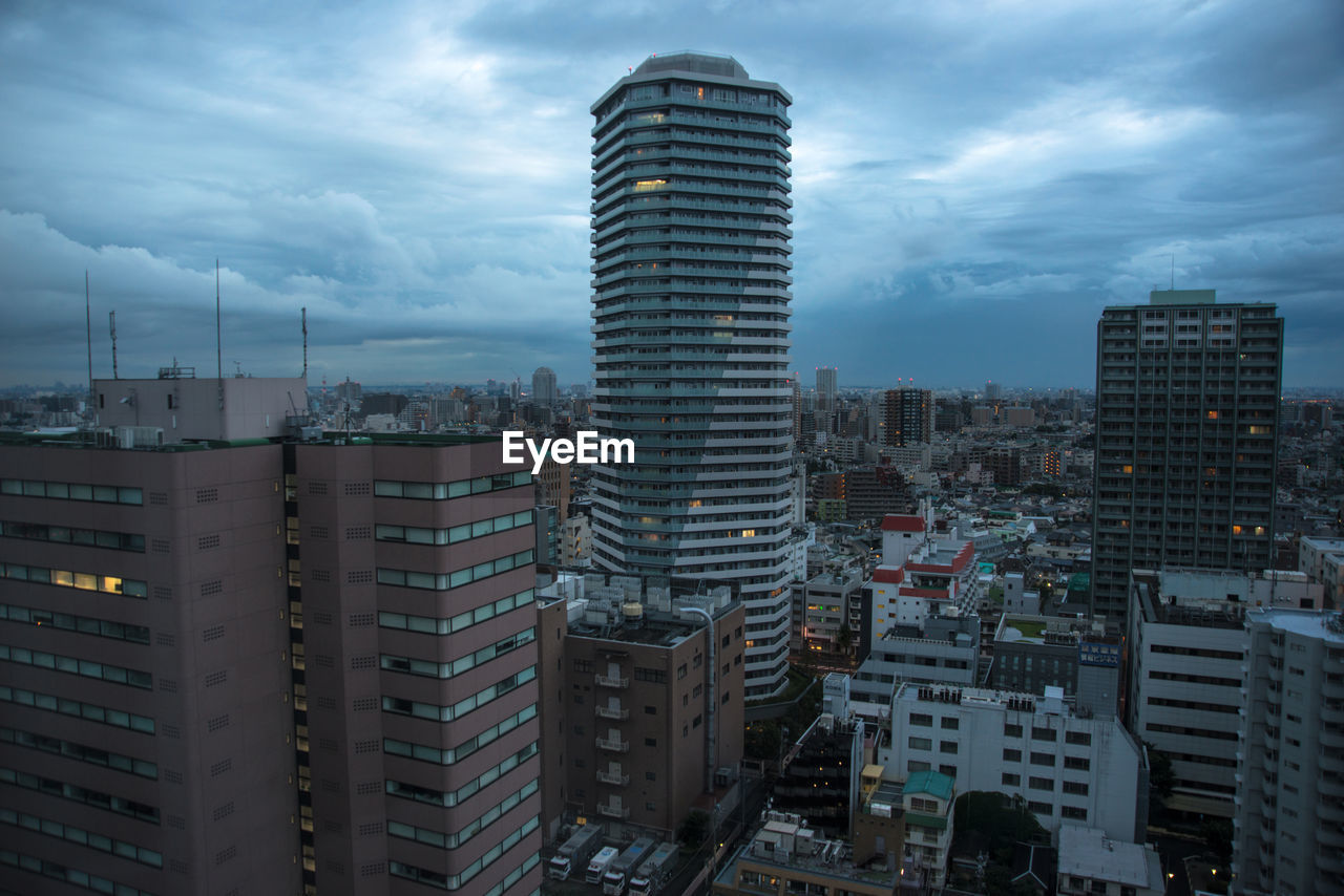 Cityscape against cloudy sky