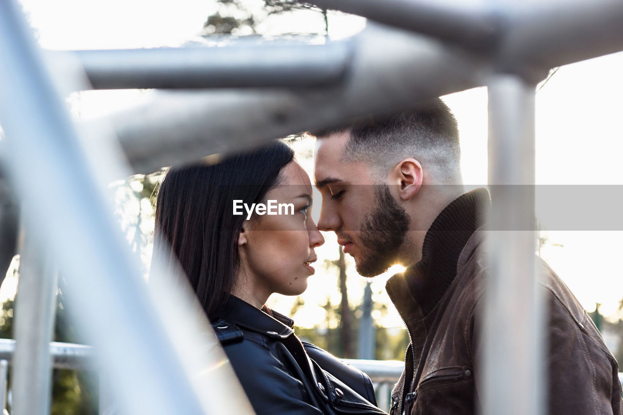 Date of couple in love with industrial style, young people at steel construction, casual lifestyle