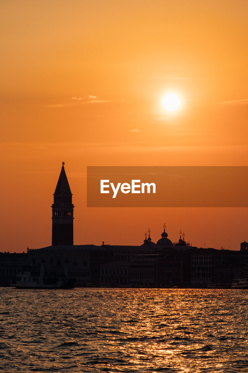 Grand canal by silhouette church of san giorgio maggiore against sky during sunset