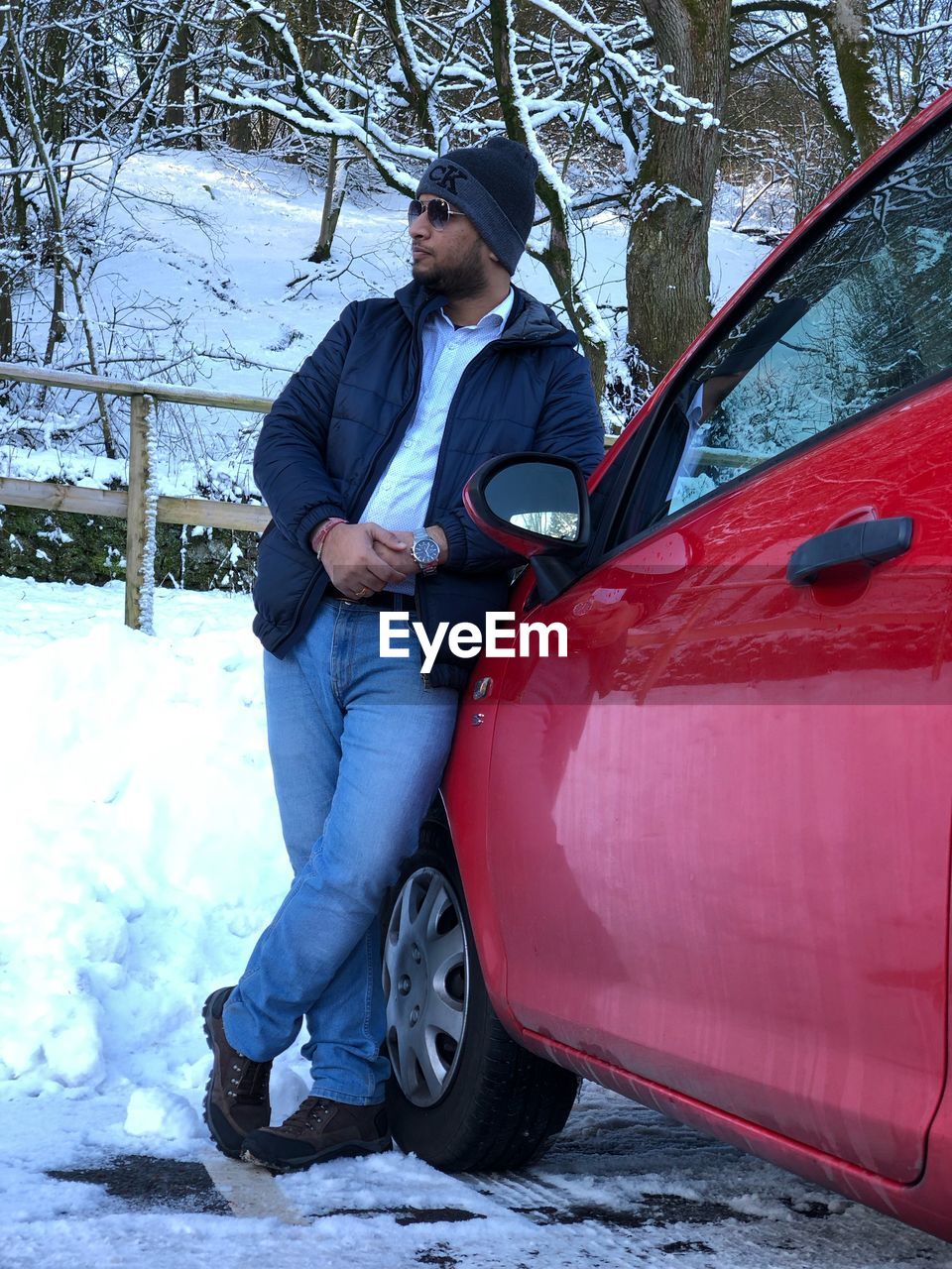 YOUNG MAN STANDING IN SNOW