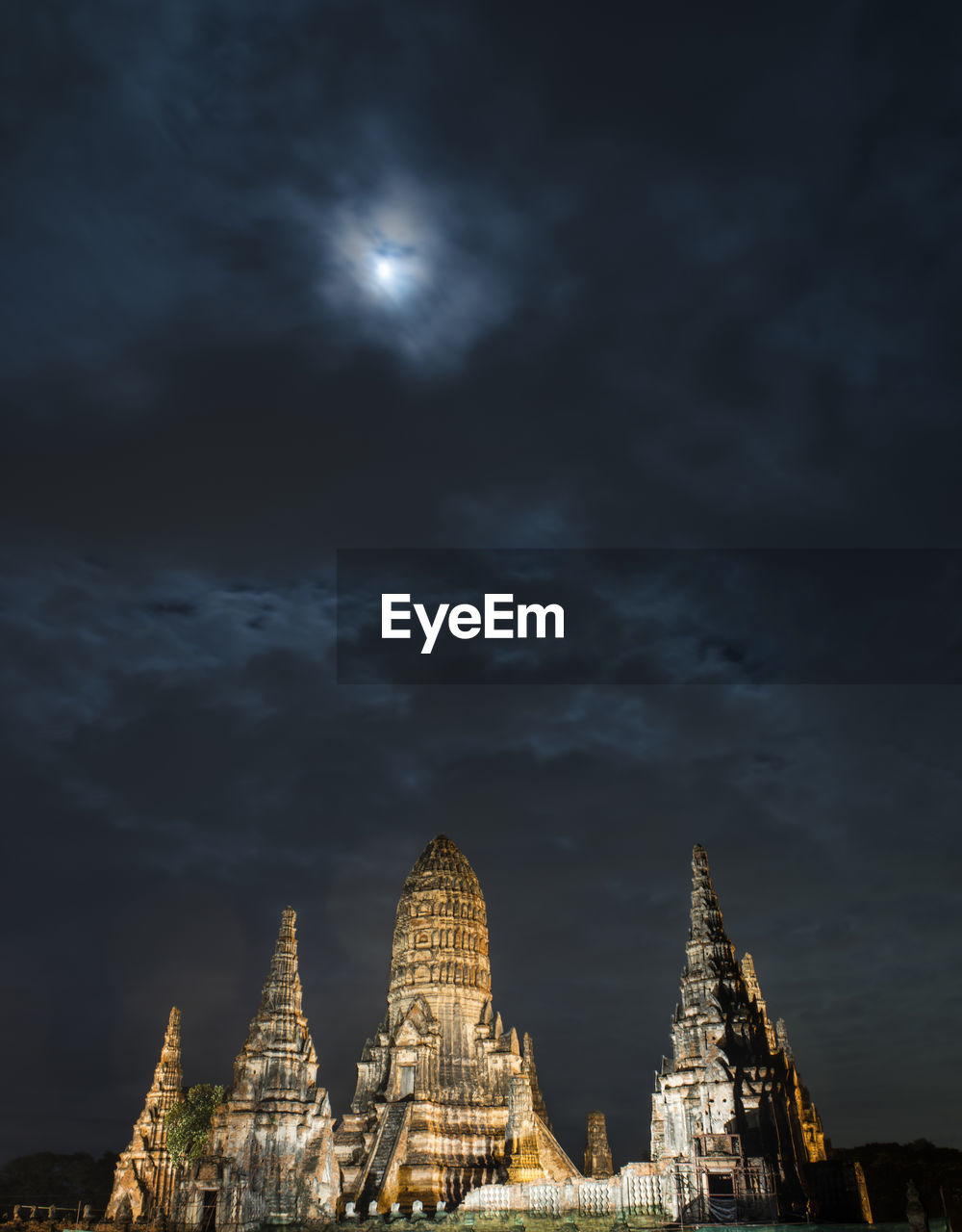 Pagodas against cloudy sky during night at phra nakhon si ayutthaya