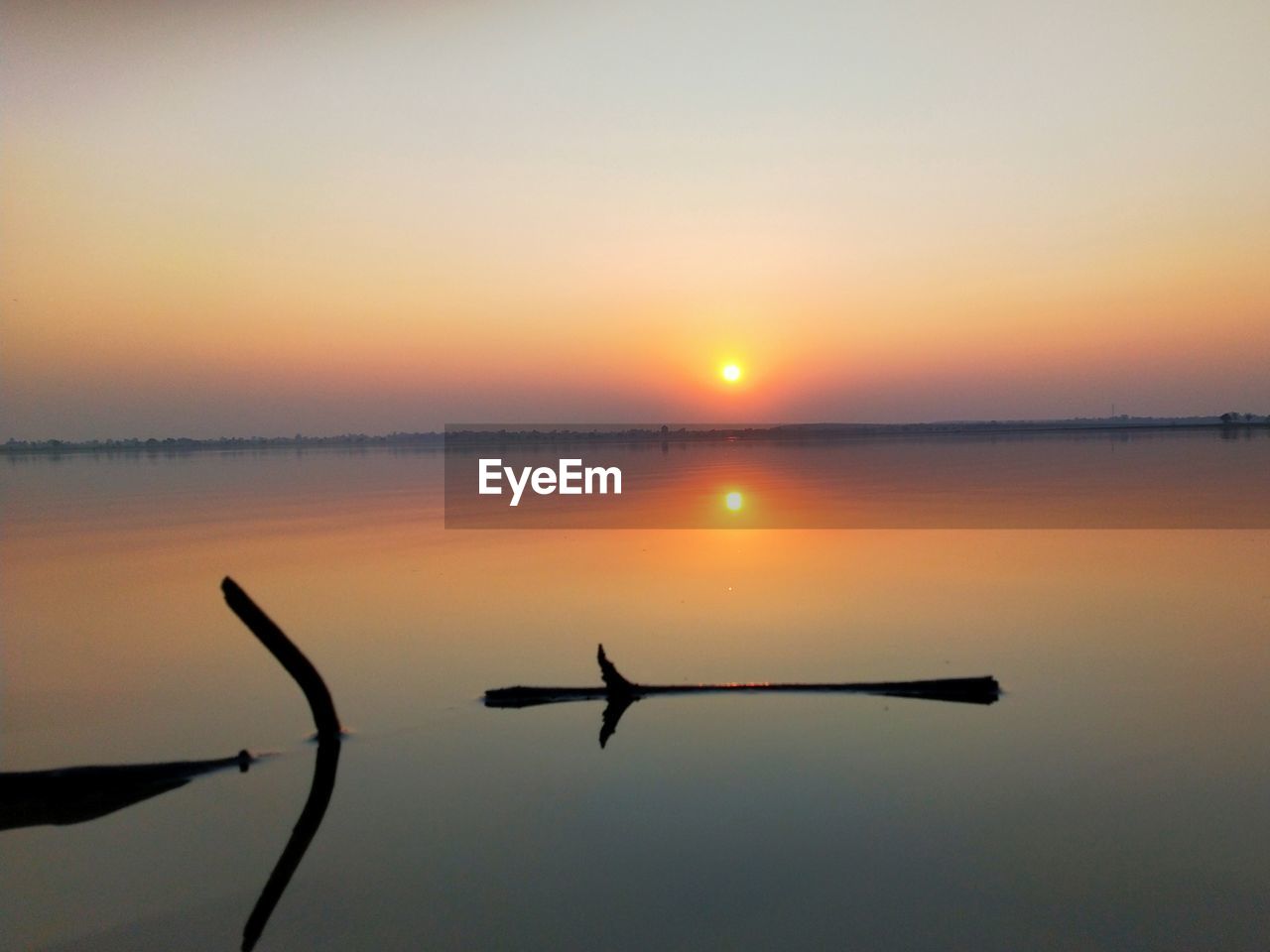 SCENIC VIEW OF SUNSET OVER LAKE