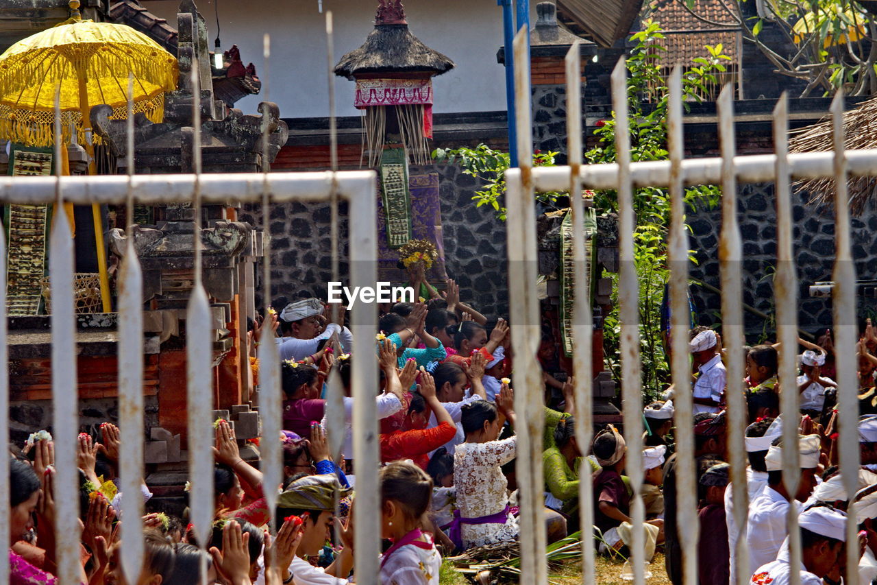 GROUP OF PEOPLE IN FRONT OF TRADITIONAL BUILDING