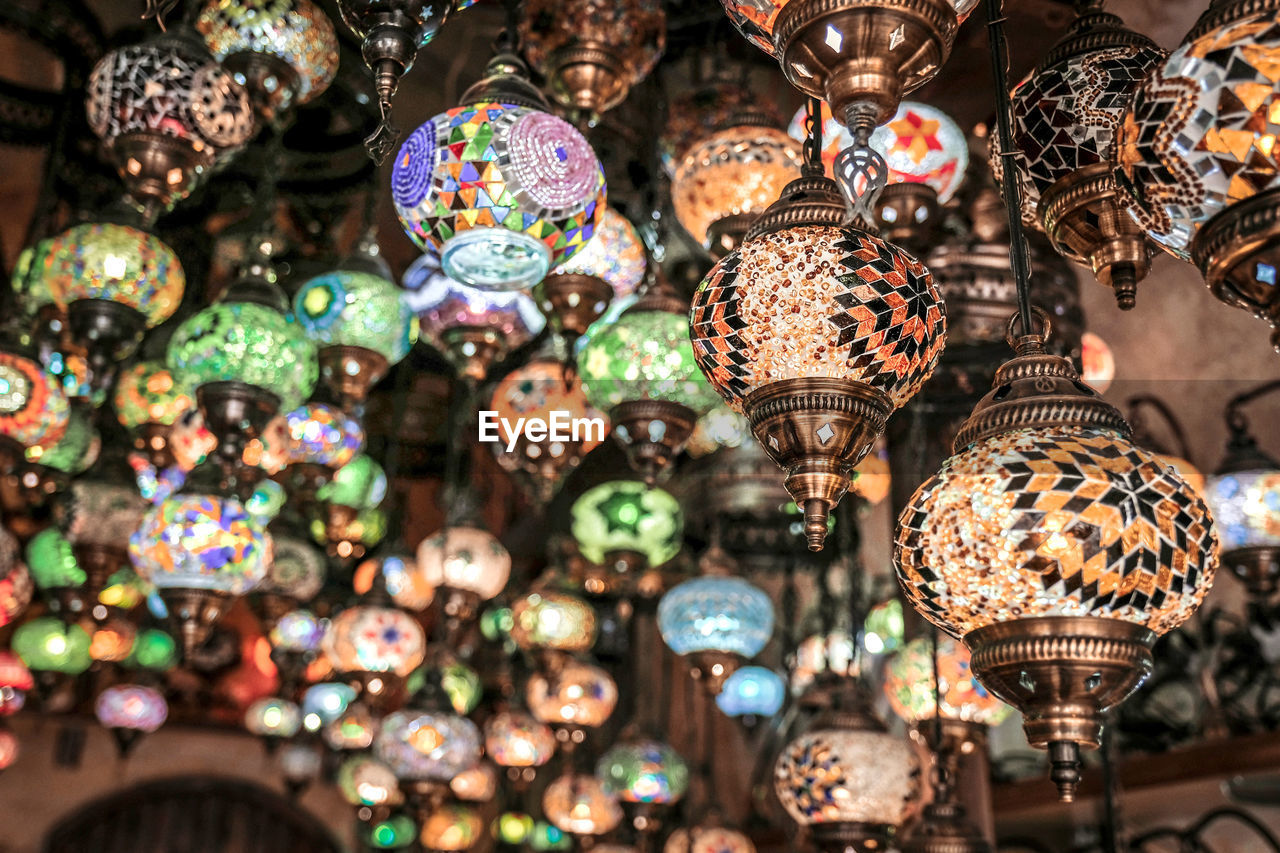 LOW ANGLE VIEW OF ILLUMINATED CHANDELIER