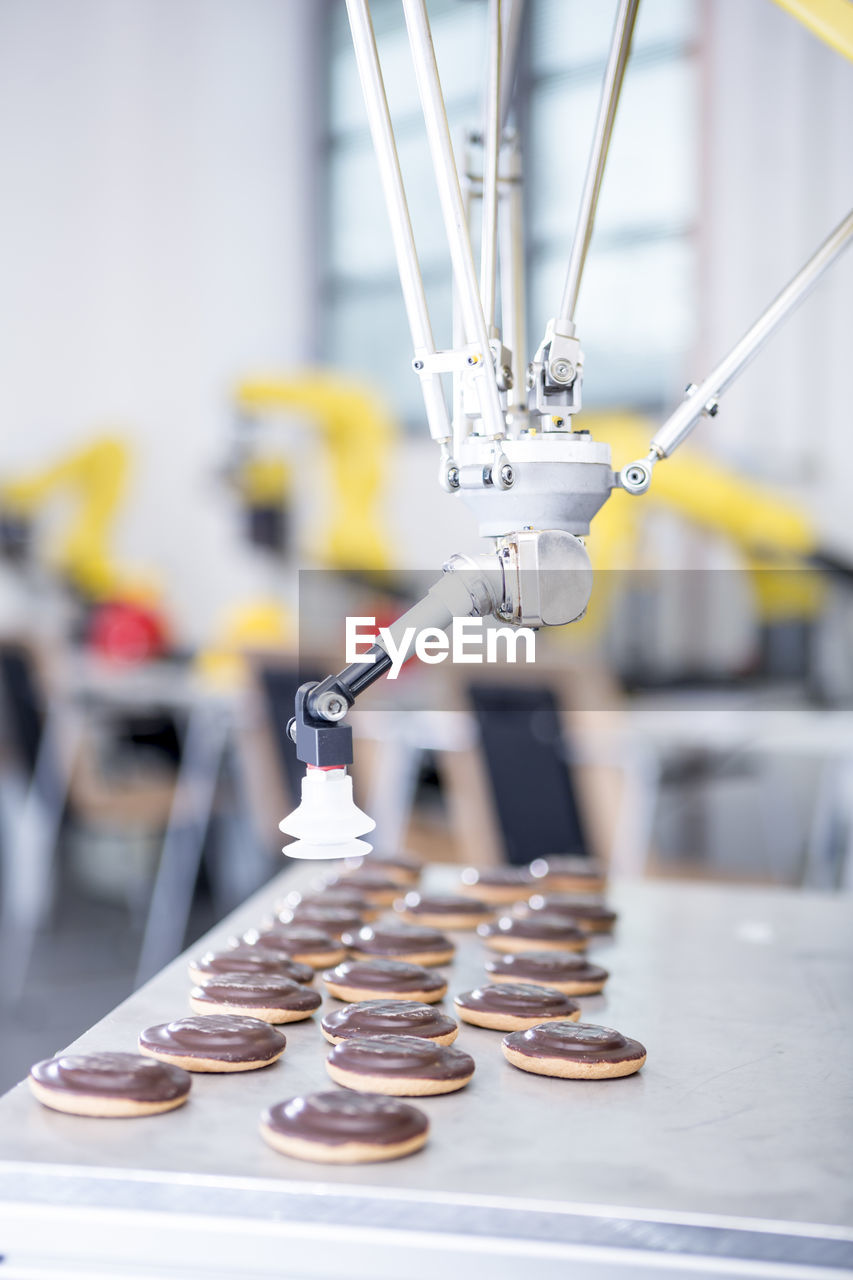 Close-up of industrial robot handling cookies