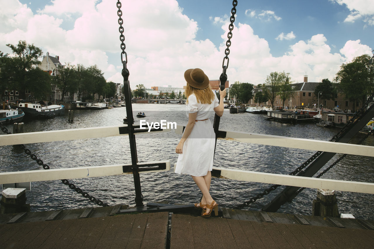 Woman on bridge overlooking city