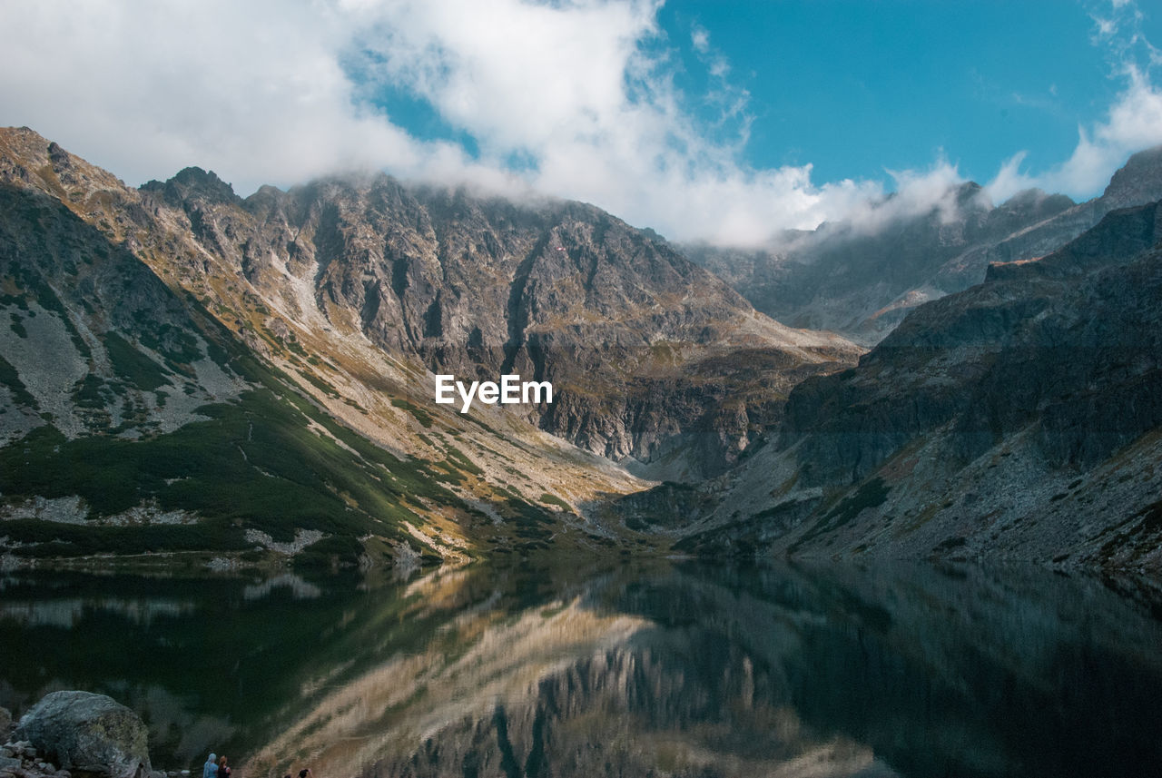 Scenic view of mountains against cloudy sky