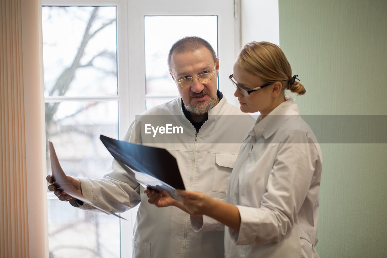 Doctors discussing over x-ray in hospital