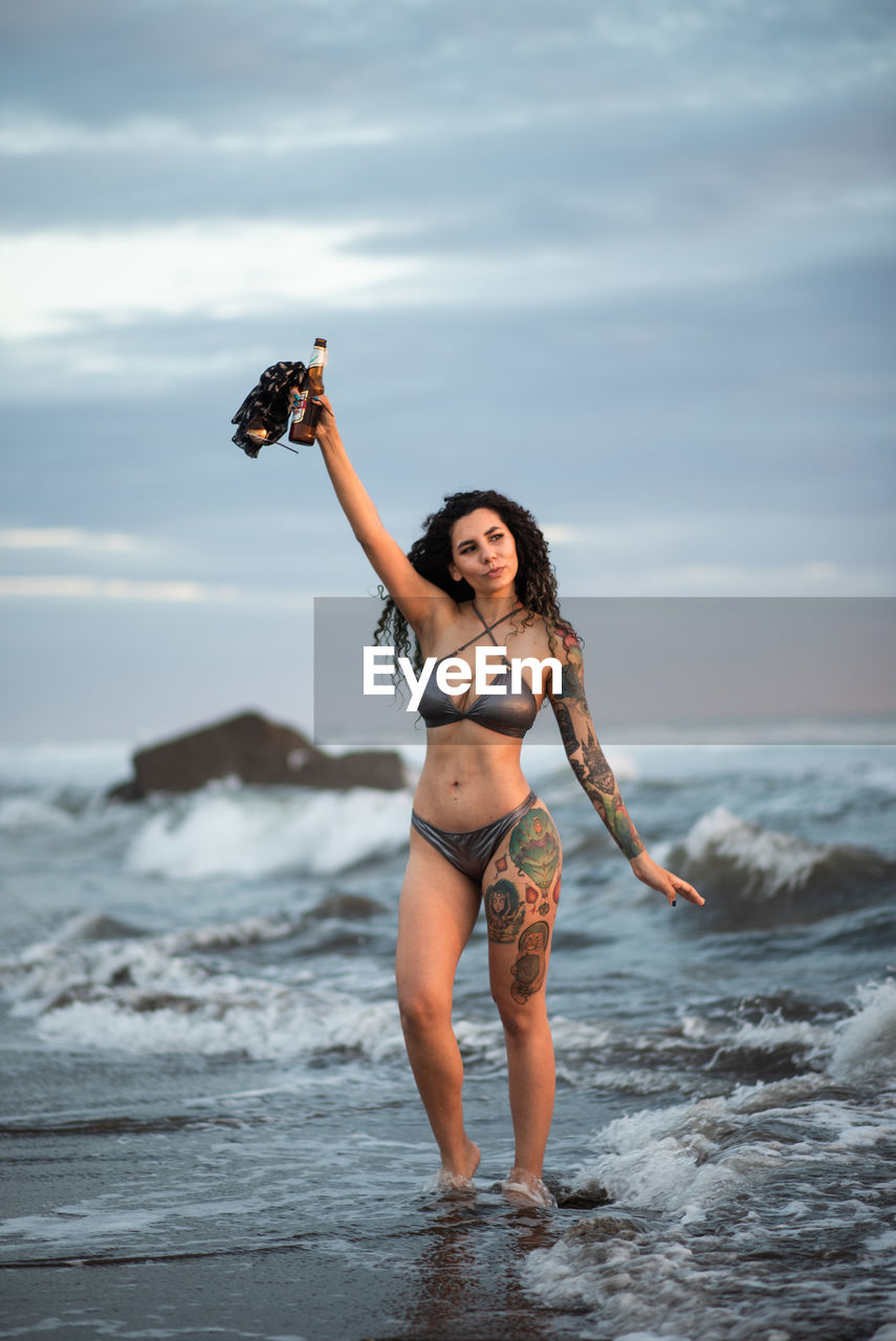 Full length of woman standing on beach