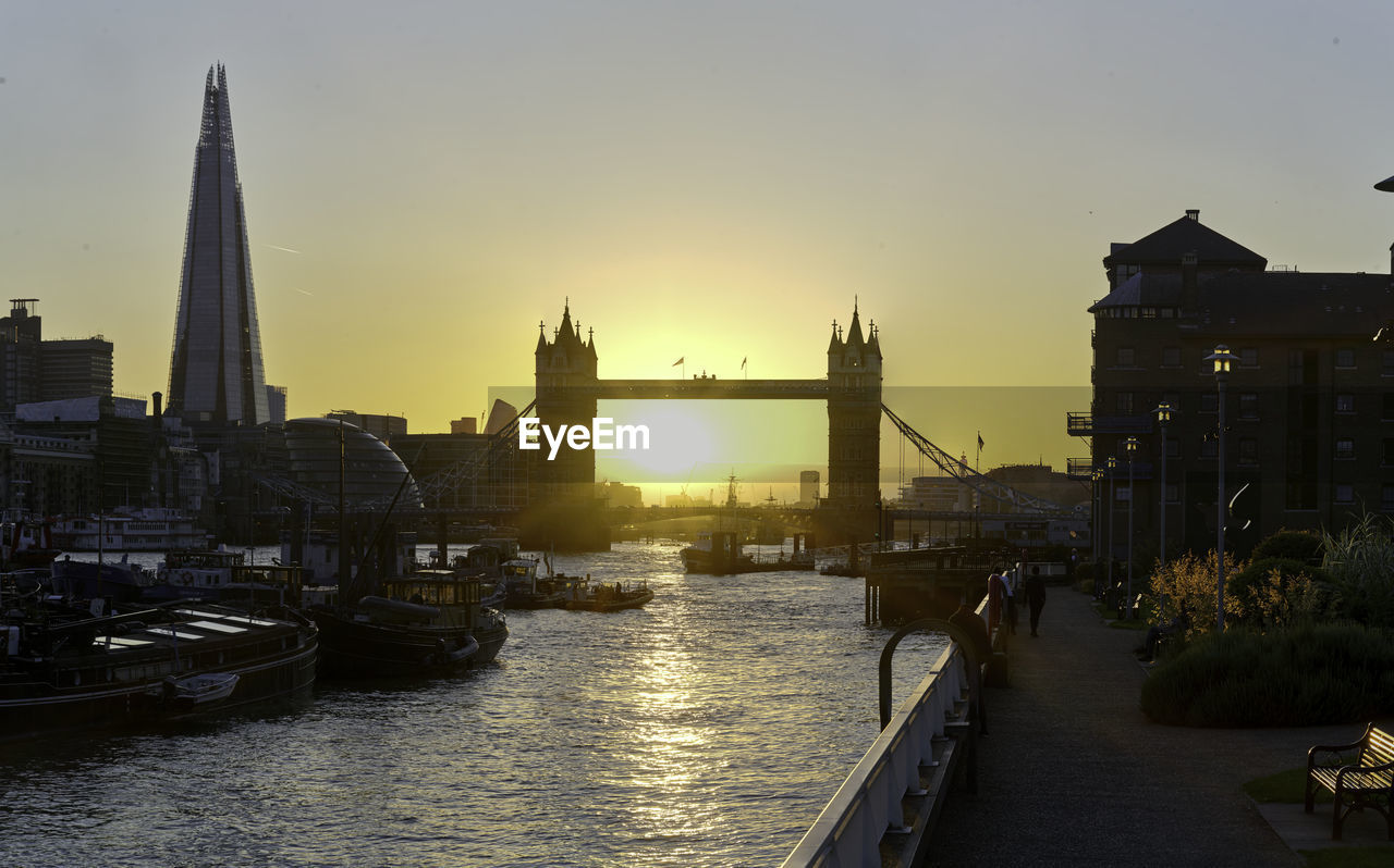 View of tower bridge at waterfront during sunset