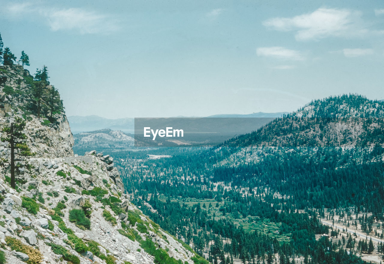 high angle view of trees and mountains against sky