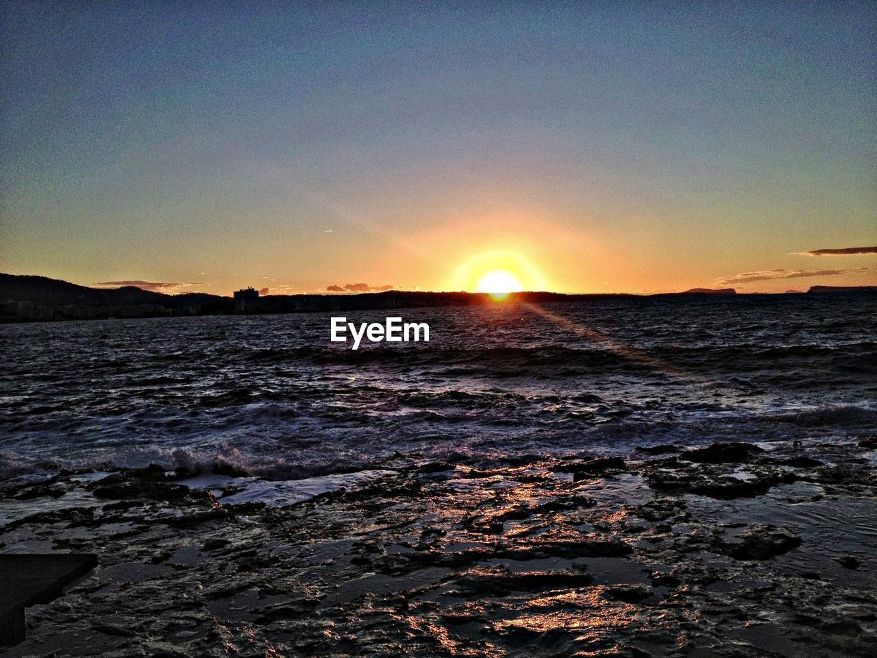 Scenic view of sea against clear sky during sunset